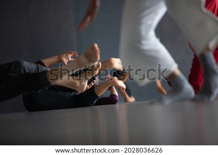 several dancers move on floor n contact improvisation performance intentionally with motion blur ond defocus bokeh [[stock_photo]] © 