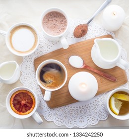 Several different hot drinks on the white table - coffee shop menu