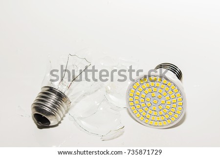 Several different led bulbs and compact fluorescent lamps with the size of the male screw base E27 on a light background