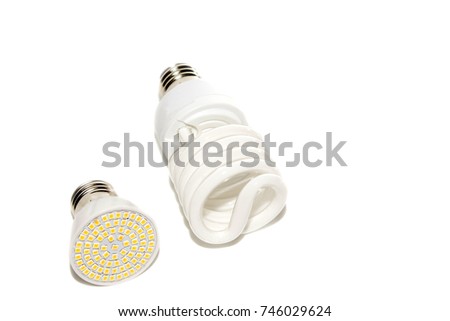 Several different led bulbs and compact fluorescent lamps with the size of the male screw base on a light background