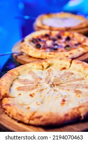 Several Different Pizzas On A Nightclub Table