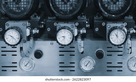 Several digital measuring indicators in a row installed on an industrial machine, industrial concept background.