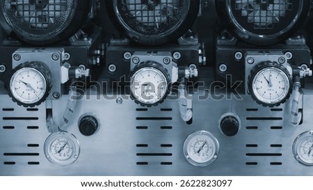Several digital measuring indicators in a row installed on an industrial machine, industrial concept background.