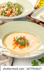 Several Dishes Of Pumpkin Soup, Salad And Sandwich