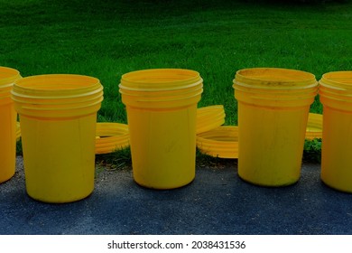 Several Empty Garbage Cans At The End Of The Driveway