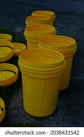 Several Empty Garbage Cans At The End Of The Driveway