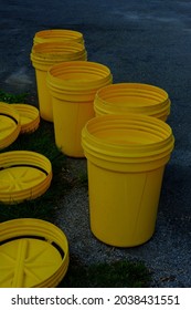 Several Empty Garbage Cans At The End Of The Driveway