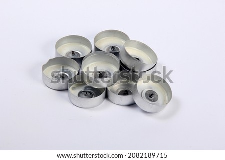 Several empty used tea candles on a white background. Empty Aluminum Cups for Tea Candles Isolated 