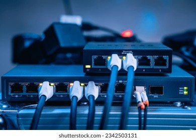 Several ethernet cables linked to a network router for establishing an internet connection