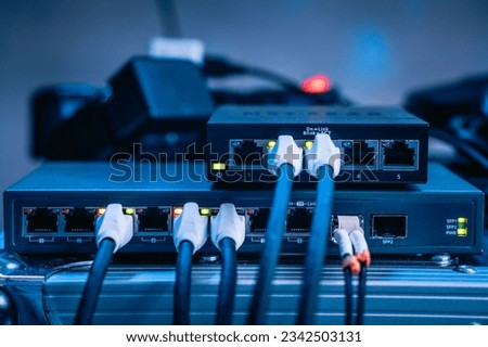 Several ethernet cables linked to a network router for establishing an internet connection