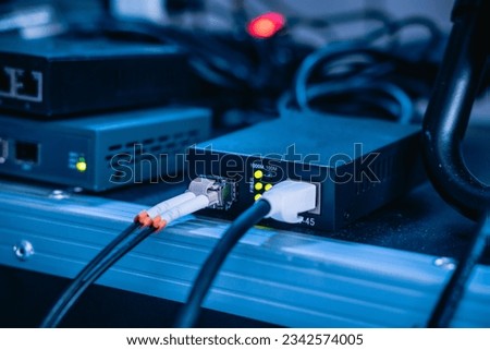 Several ethernet cables linked to a network router for establishing an internet connection