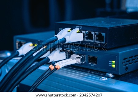 Several ethernet cables linked to a network router for establishing an internet connection