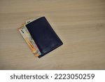 several euro banknotes stored in a wallet (purse) to show wealth or cost of living, inflation