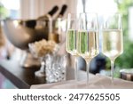 several filled champagne glasses in a festive setting, wedding, celebration, party.