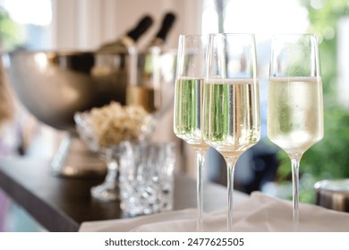 several filled champagne glasses in a festive setting, wedding, celebration, party.