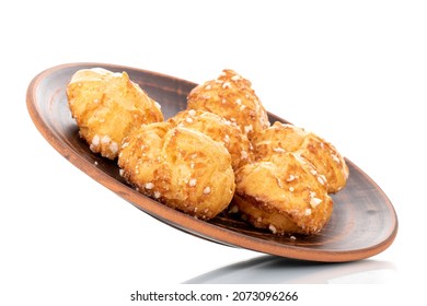 Several fragrant Chouquette on a ceramic dish, close-up, isolated on white.