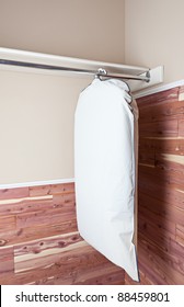 Several Garments In A Garment Bag, Hanging In A Cedar Lined Closet.