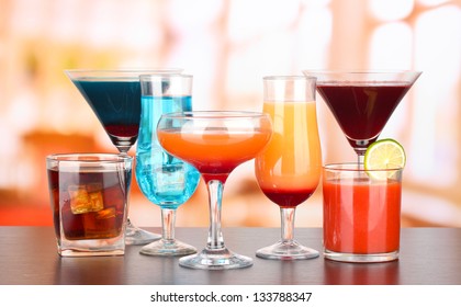 Several glasses of different drinks on bright background - Shutterstock ID 133788347