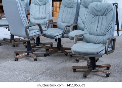 Several Gray Leather Office Chairs Ready For Packaging In A Furniture Warehouse, Online Furniture Store.