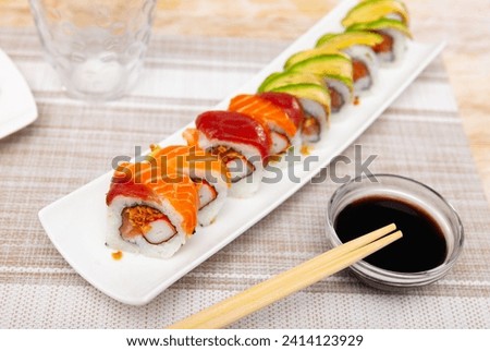 For several guests, Japanese lunch is served - set of uramaki rolls, soy sauce, chopsticks Stock photo © 