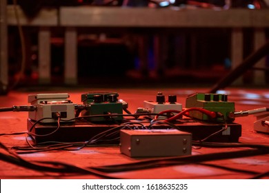 Several guitar pedals for processing different audio effects on a concert.