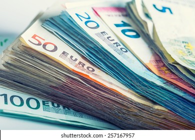 Several hundred euro  banknotes stacked by value.  - Powered by Shutterstock