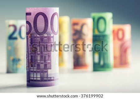 Several hundred rolls of euro banknotes in different positions.