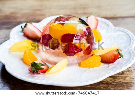 Several kind of fresh fruit in clear jelly.