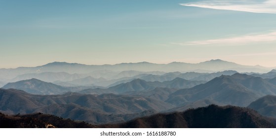 Several layers of mountains, viewed from high mountains in Korea, are superb with light fog. - Powered by Shutterstock