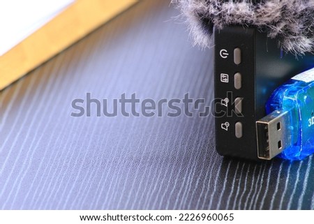 several menu buttons from a wireless mic with a noise filter and a blue soundcard