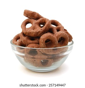 Several Milk Chocolate Covered Pretzels In Glass Bowl On White Background 