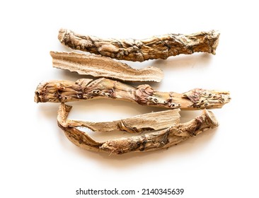 several pieces of dried Sweet flag (calamus) root on white plate