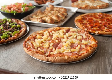 Several pizzas on a dining table