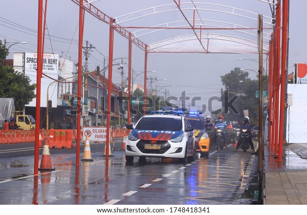 Several police officers are arranging\
traffic in Purwokerto Indonesia on April 17,\
2020