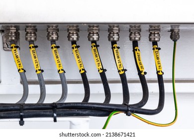 Several powerful electrical cables connected to a junction box. - Shutterstock ID 2138671421
