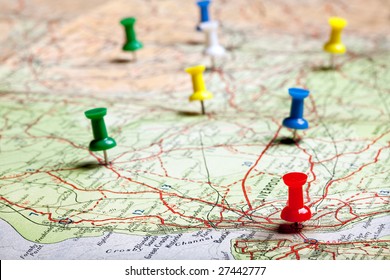 Several pushpins on a road-map of a tourist - Shutterstock ID 27442777