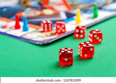 Several Red Dice For Board Games On A Green Background