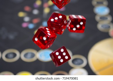 Several Rolling Red Dice Fall On A Table With Boardgame. Gameplay Moments.