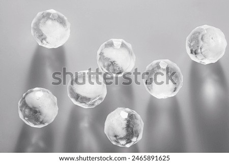 Several round ice cubes are placed on a gray table.