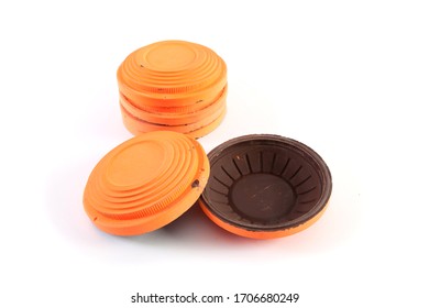 Several Round Orange Target Cymbal Targets Stacked In A Stack On A White Background. One Target Wrapped In Reverse. Close-up

