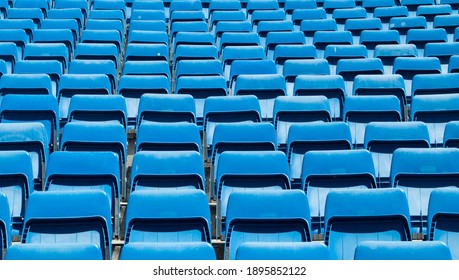 Several Rows Of Closed Blue Empty Seats In A Sports Stadium During The Corona Pandemic