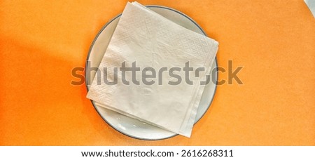 several sheets of tissue folded on a plate