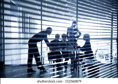 Several silhouettes of businesspeople interacting  background business centrer
