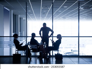 Several silhouettes of businesspeople interacting  background business center