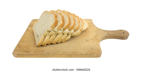 Several Slices Of Freshly Baked English Muffin Toasting Bread Atop An Old Wood Cutting Board Isolated On A White Background.