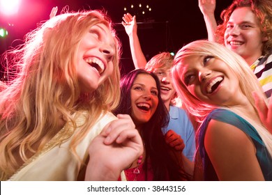 Several smiling dancers having fun during disco - Powered by Shutterstock