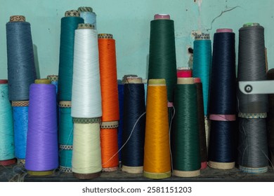 Several spools of thread standing upright