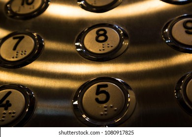 several stainless steel elevator panel push buttons, metal buttons in the Elevator, selective focus
