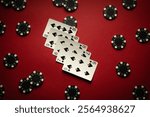 Several straight flush playing cards lie on a red table surrounded by chips. The atmosphere is charged with anticipation and poker strategy as players get involved in the game.