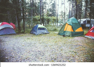 Several Tents Are Setup In A Camp Ground In The Forest